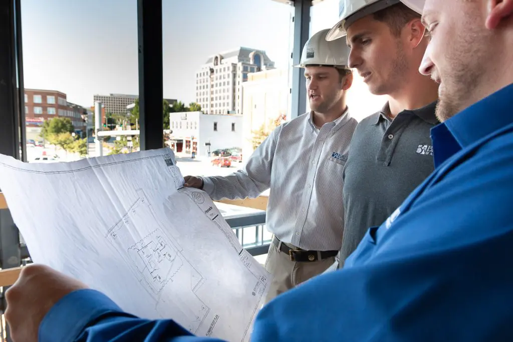 two men looking at blueprints