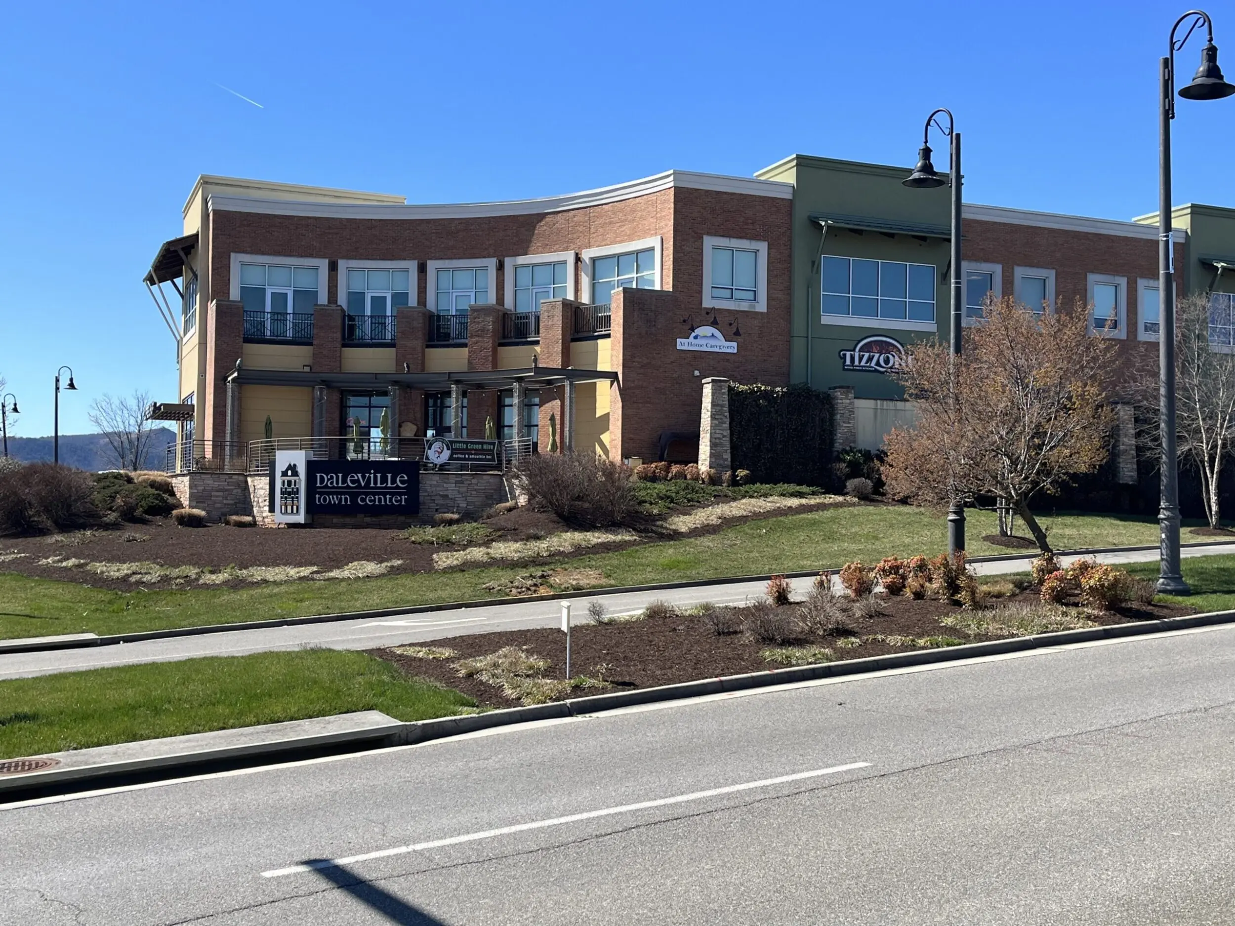 Exterior Shot of the Daleville Town Center on a sunny day. There is a road in the foreground and bright blue skies.