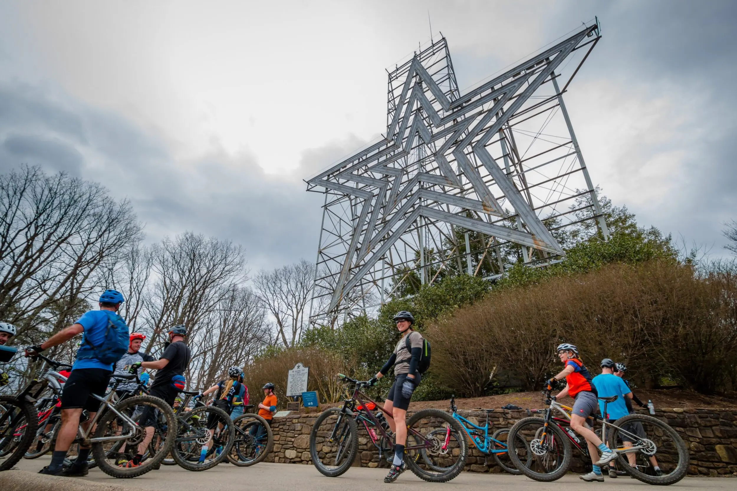 The Mill Mountain Star in Roanoke, VA, with cyclists gathered at the bottom.