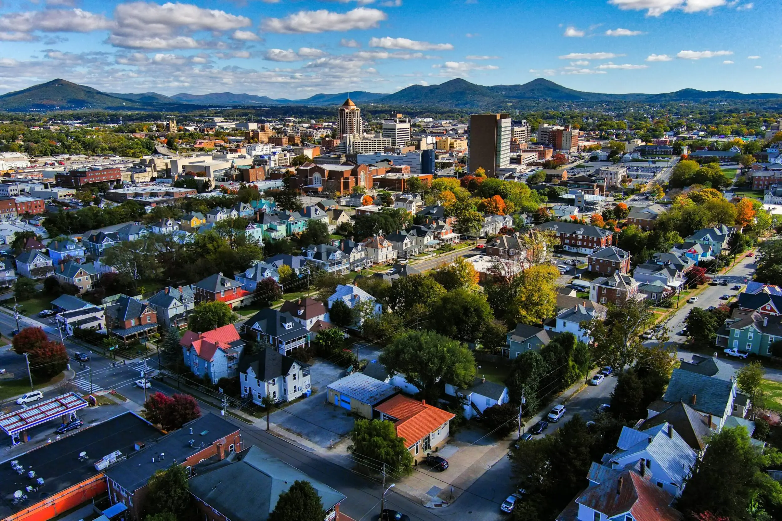 View of downtown Roanoke on a sunny summer day with the Blue Ridge Mountains in the background.