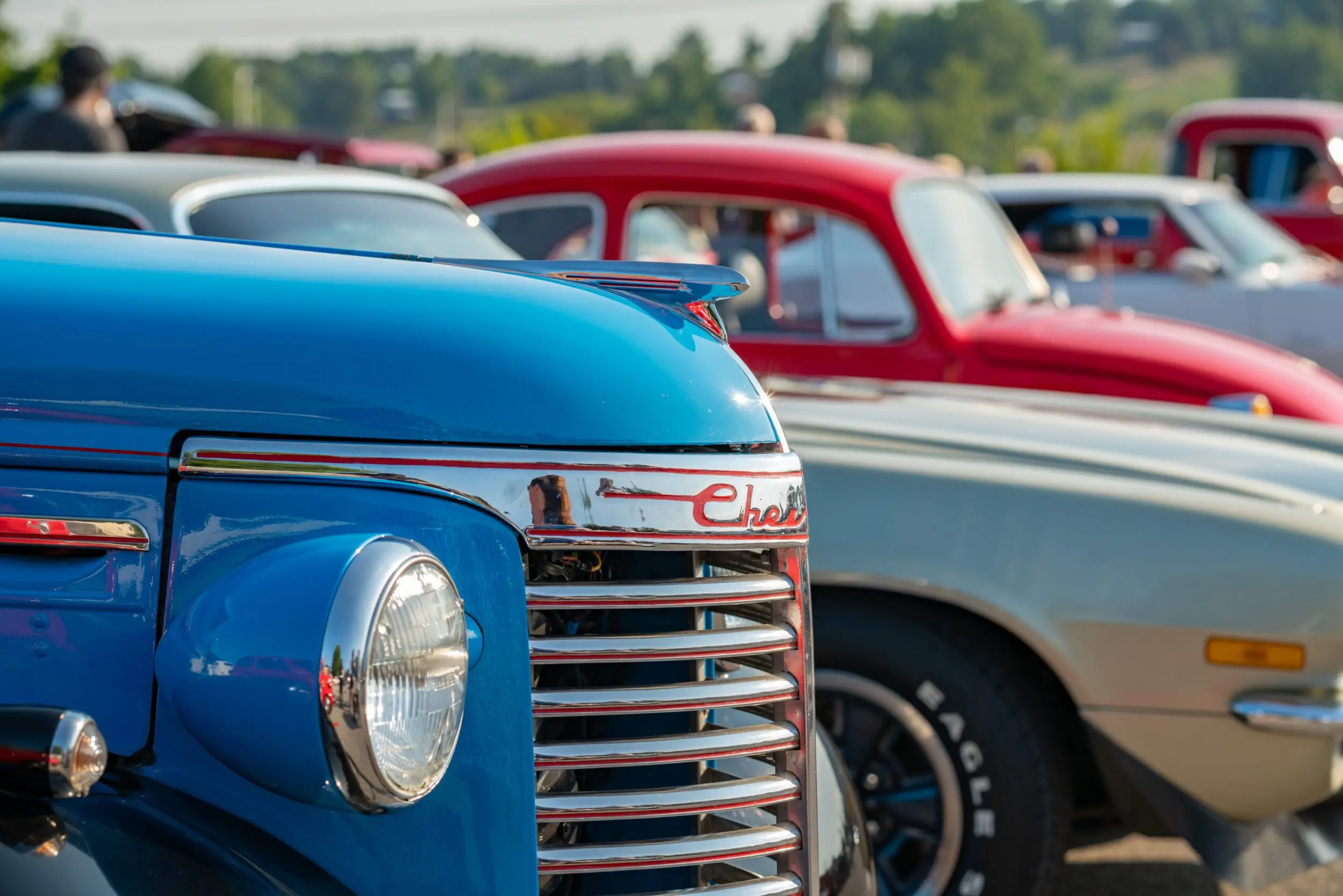 The blue hood and chrome grill of a vintage car at the Rocky Mount event, Buddy's Cruzin Vintage Car Rally in Rocky Mount, VA.