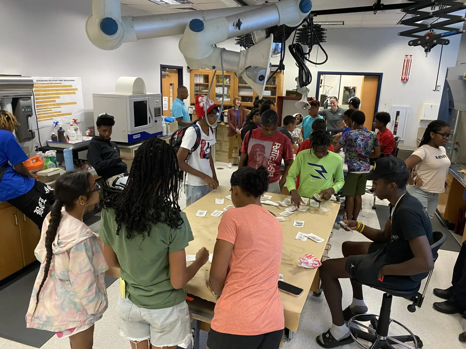 group of students standing around a table