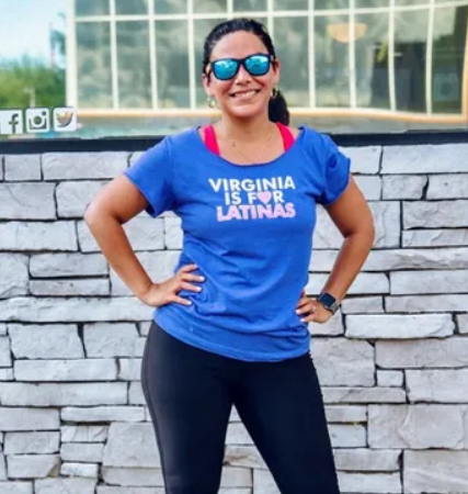 latina woman in blue shirt with hands on hips