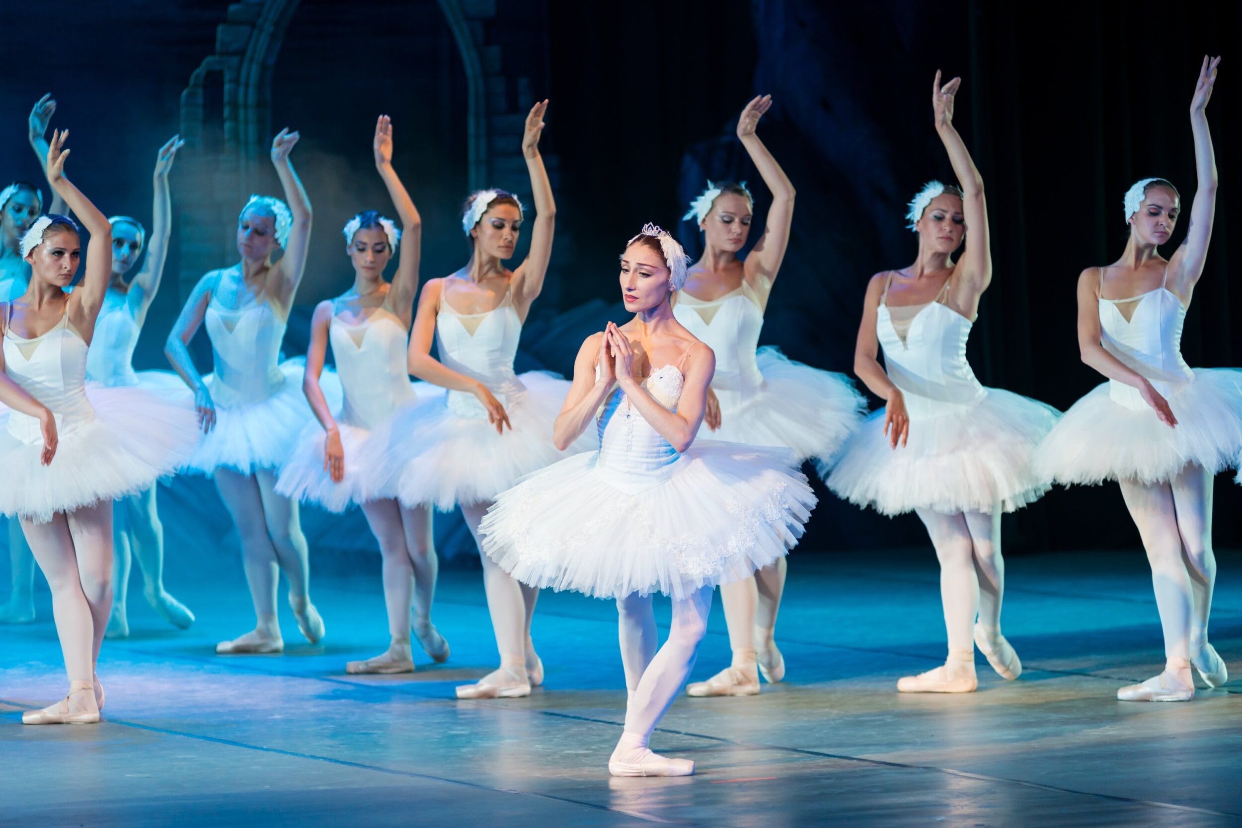 Several ballerinas in white perform 