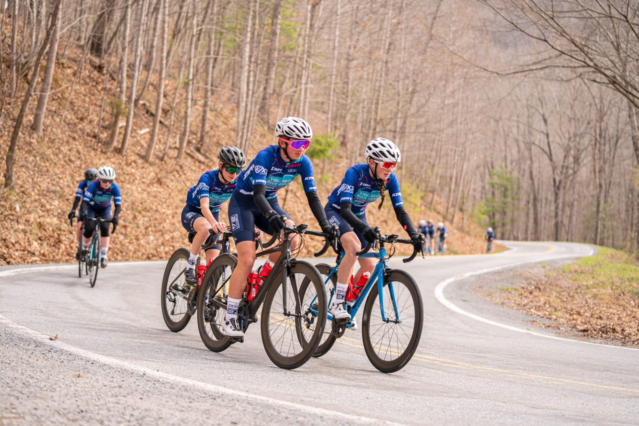 Team Twenty24 Women's USA cycling team rides along the Blue Ridge Parkway in Botetourt County. It's an overcast day in early spring, with a few buds just starting to show on the trees.