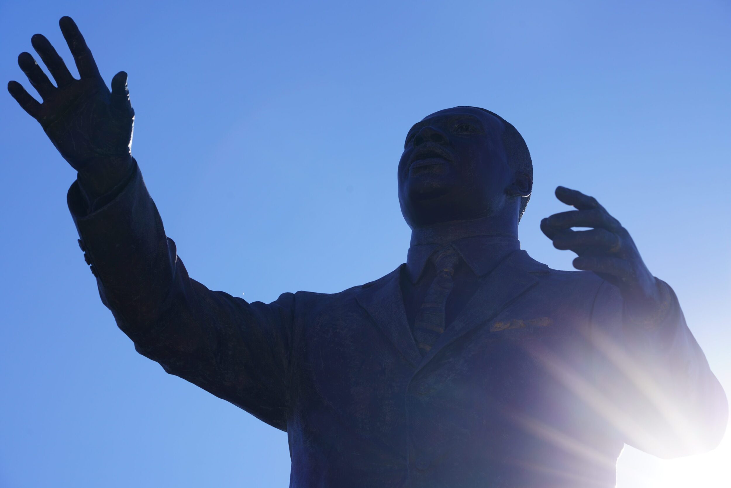 Martin Luther King, Jr., stature silhouetted against a blue sky in Roanoke, VA.