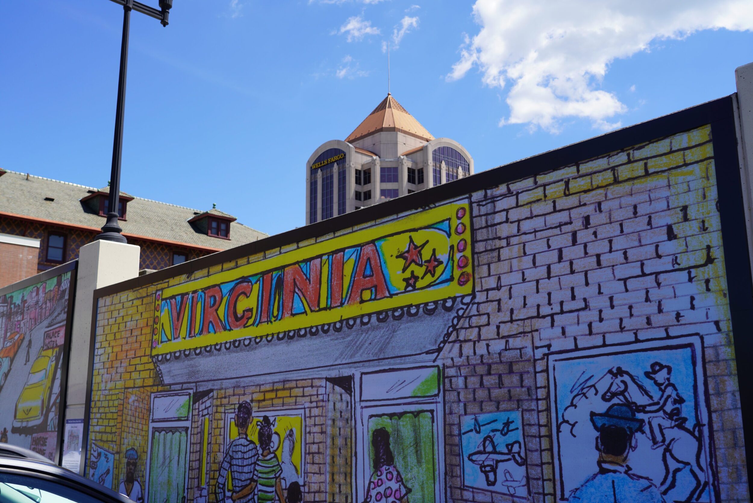 Mural depicting the Black history of the Gainsboro neighborhood in Roanoke, VA. The Wells Fargo building peeks over the top of the mural in the background.