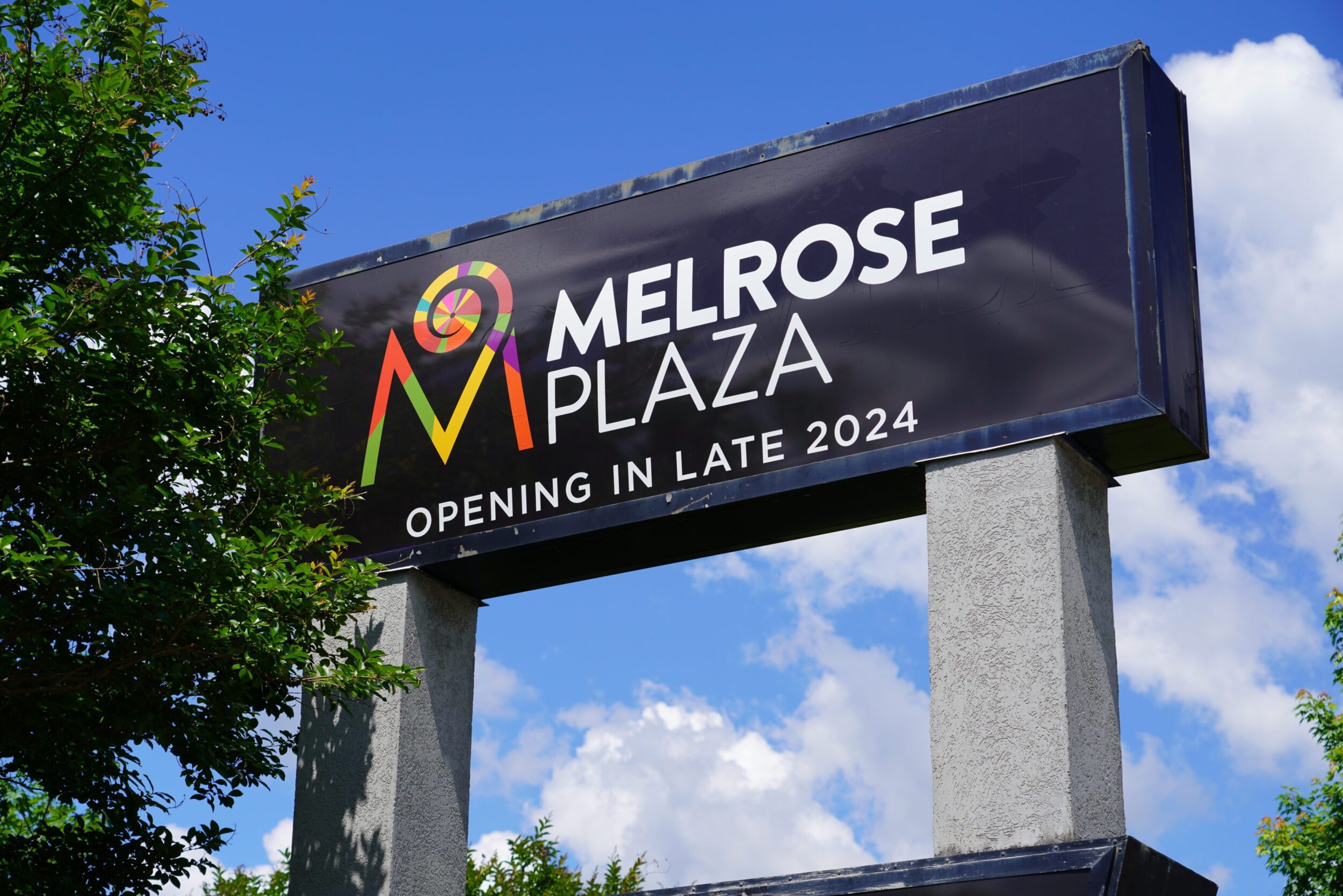 Sign for the new Melrose Plaza reding "Melrose Plaza: Opening Late 2024"