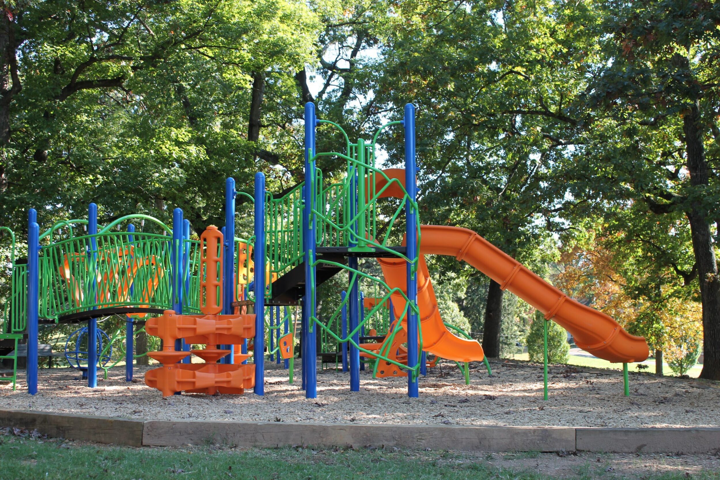 Playground structure surrounded by trees in Eureka Park located in Roanoke, VA.