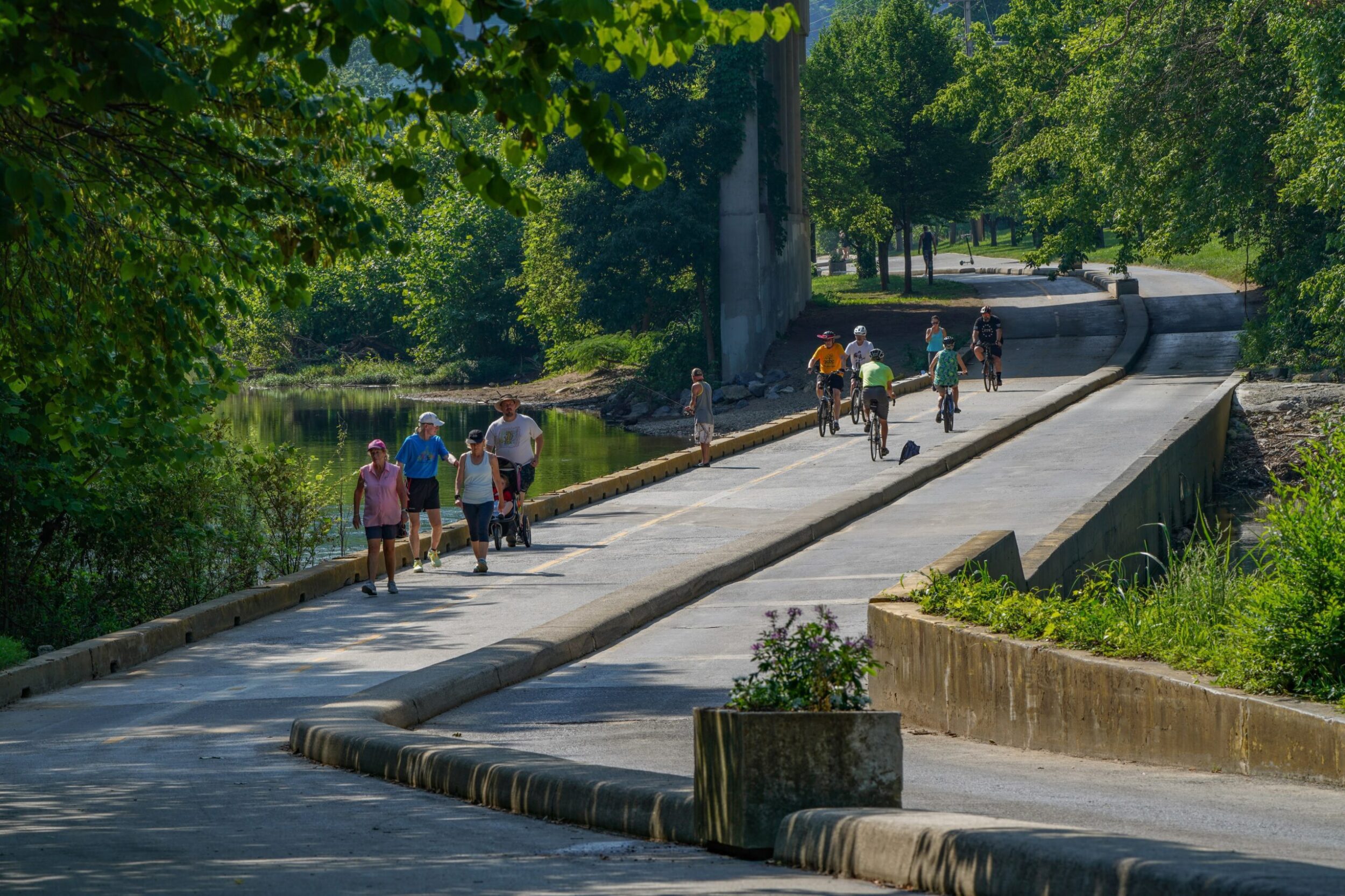 Runners, walkers, and cyclists enjoy the Roanoke River Greenway on a beautiful sunny day in Roanoke, VA.