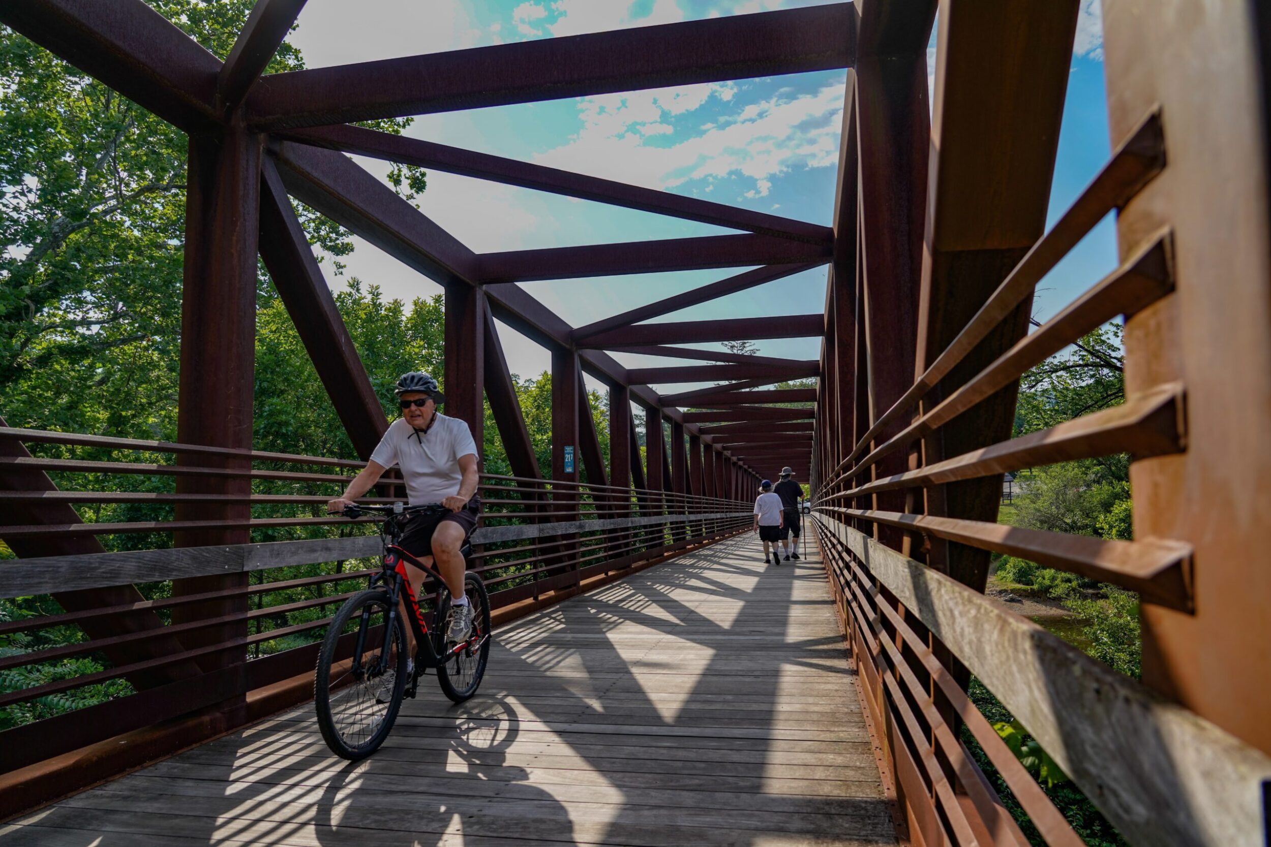 Cyclists ride on a bridge on the greenway in the Wasena neighborhood in Roanoke, VA.