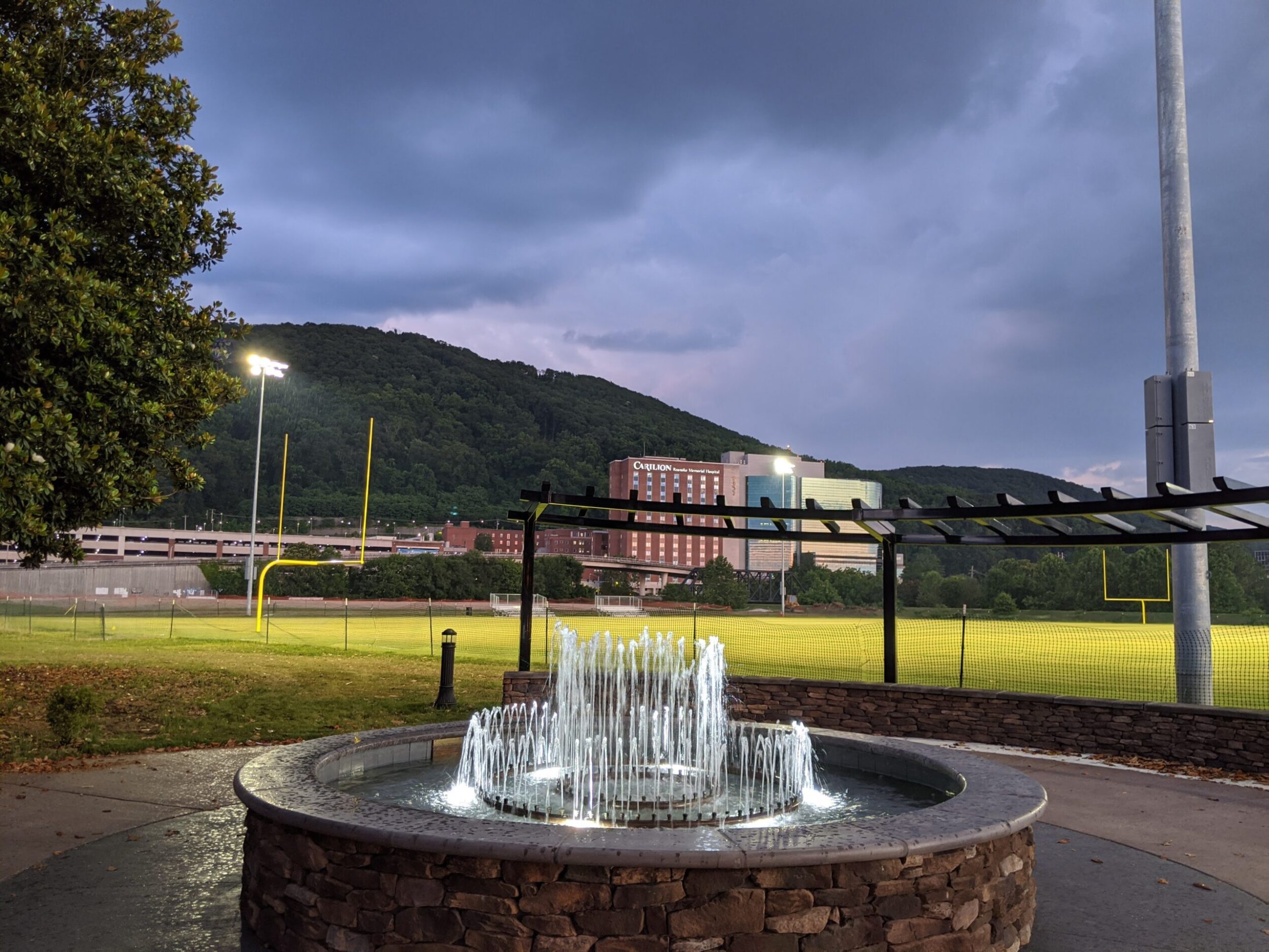 Fountain at River's Edge North park with Carilion Memorial Hospital in the background.