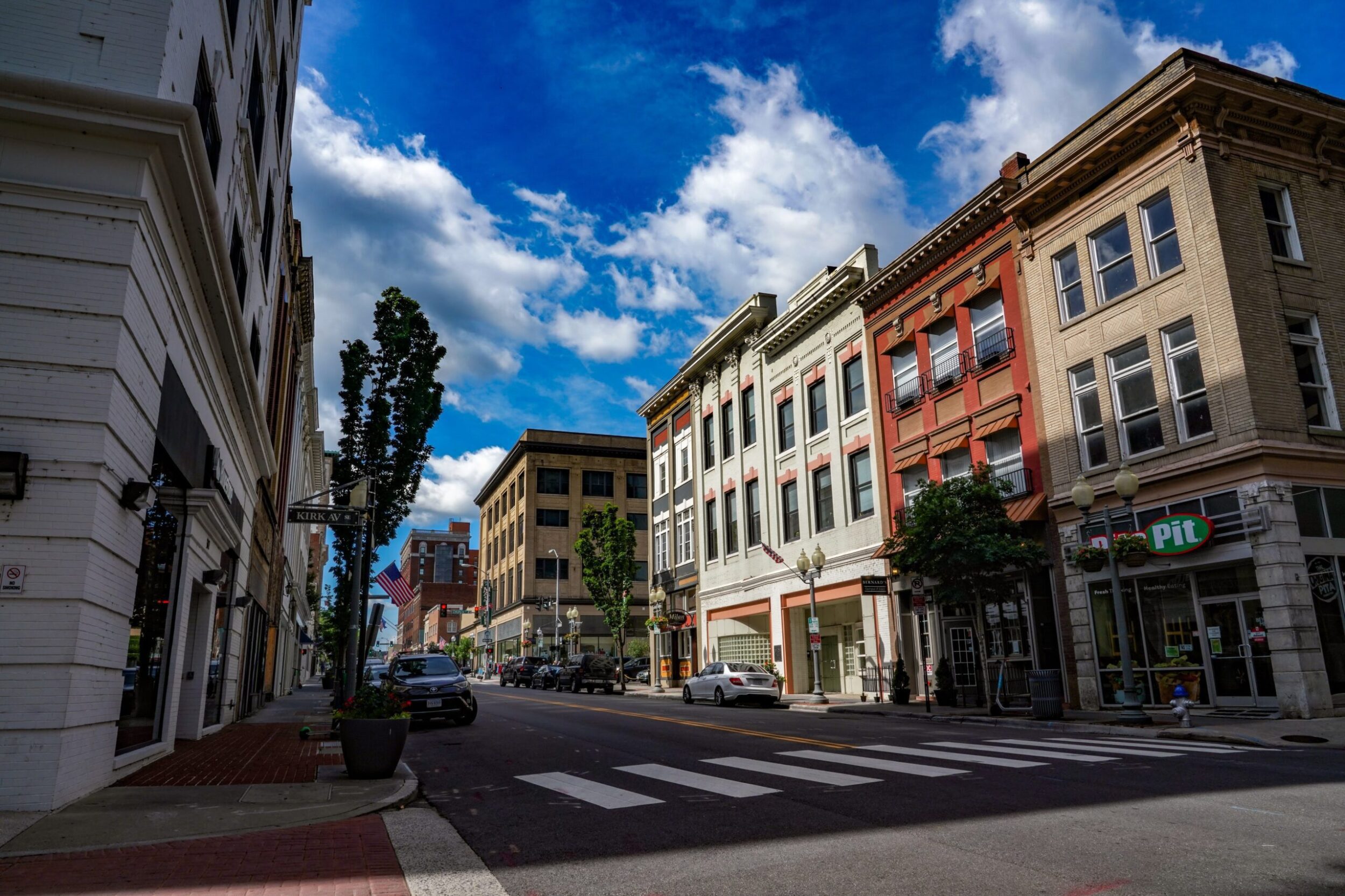 Storefronts along Campbell Avenue in downtown Roanoke on a sunny day.