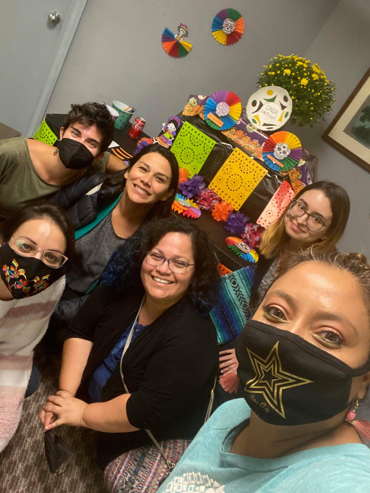 Six Hispanic people smiling for camera