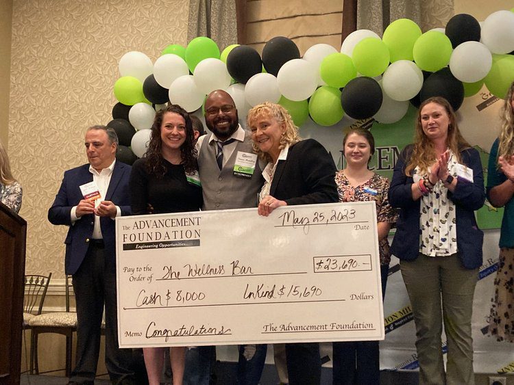 group presenting a large check